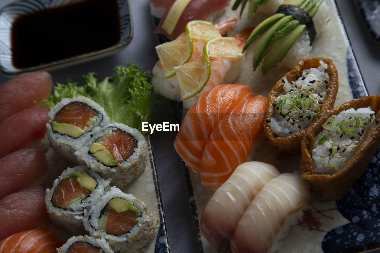 CLOSE-UP OF SUSHI SERVED ON TABLE