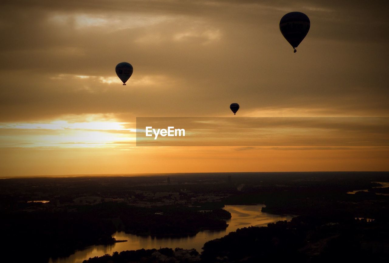 Hot air balloons over river