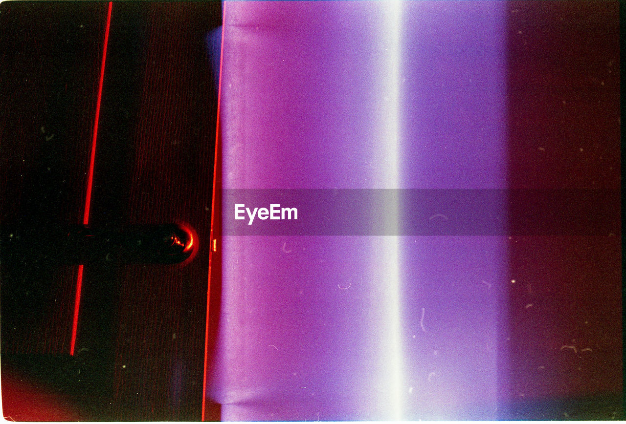 CLOSE UP VIEW OF ILLUMINATED PURPLE LIGHTS