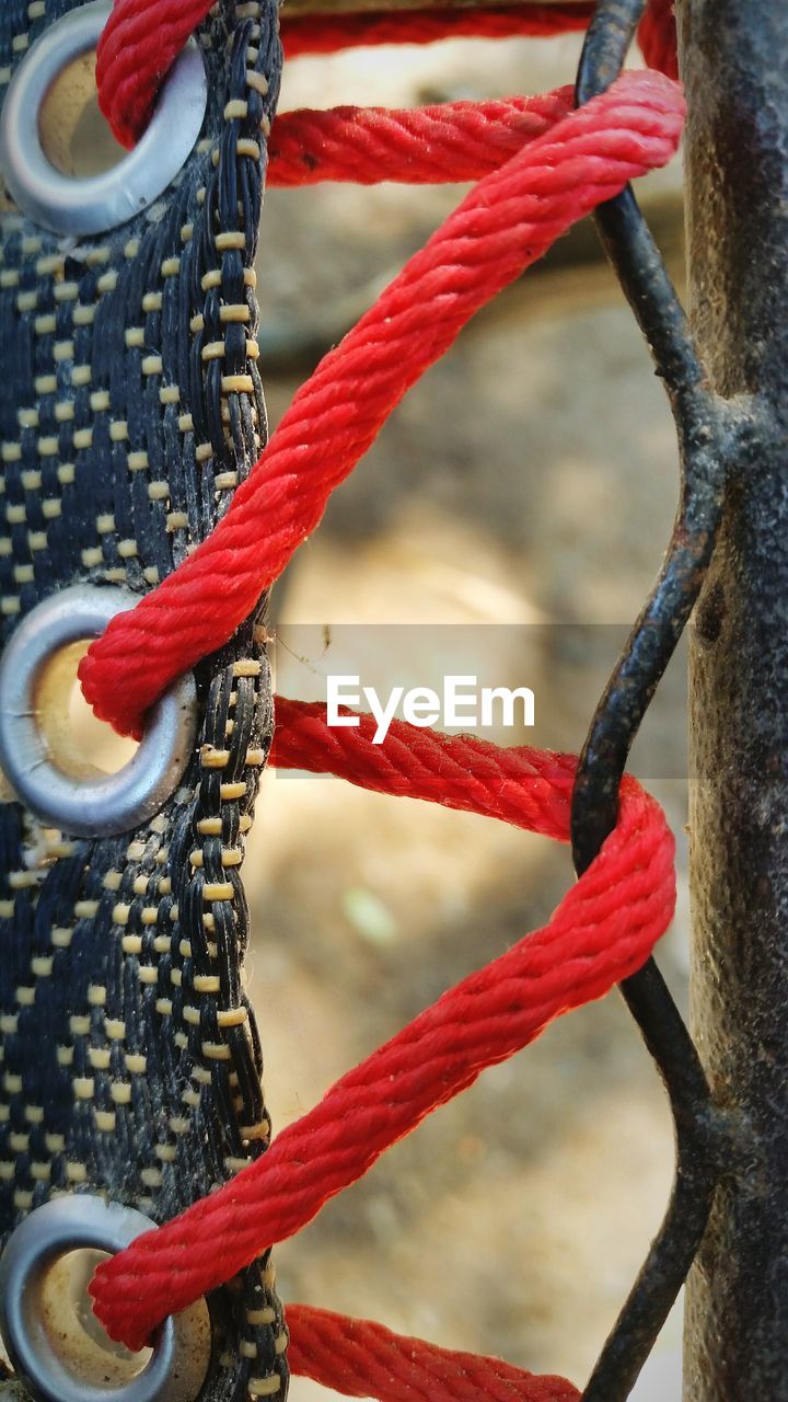 Close-up of rope tied on fence