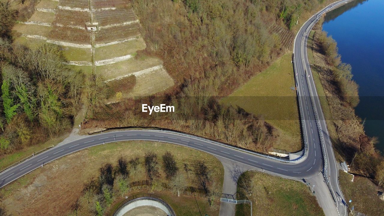 HIGH ANGLE VIEW OF ROAD AMIDST TREES ON LANDSCAPE