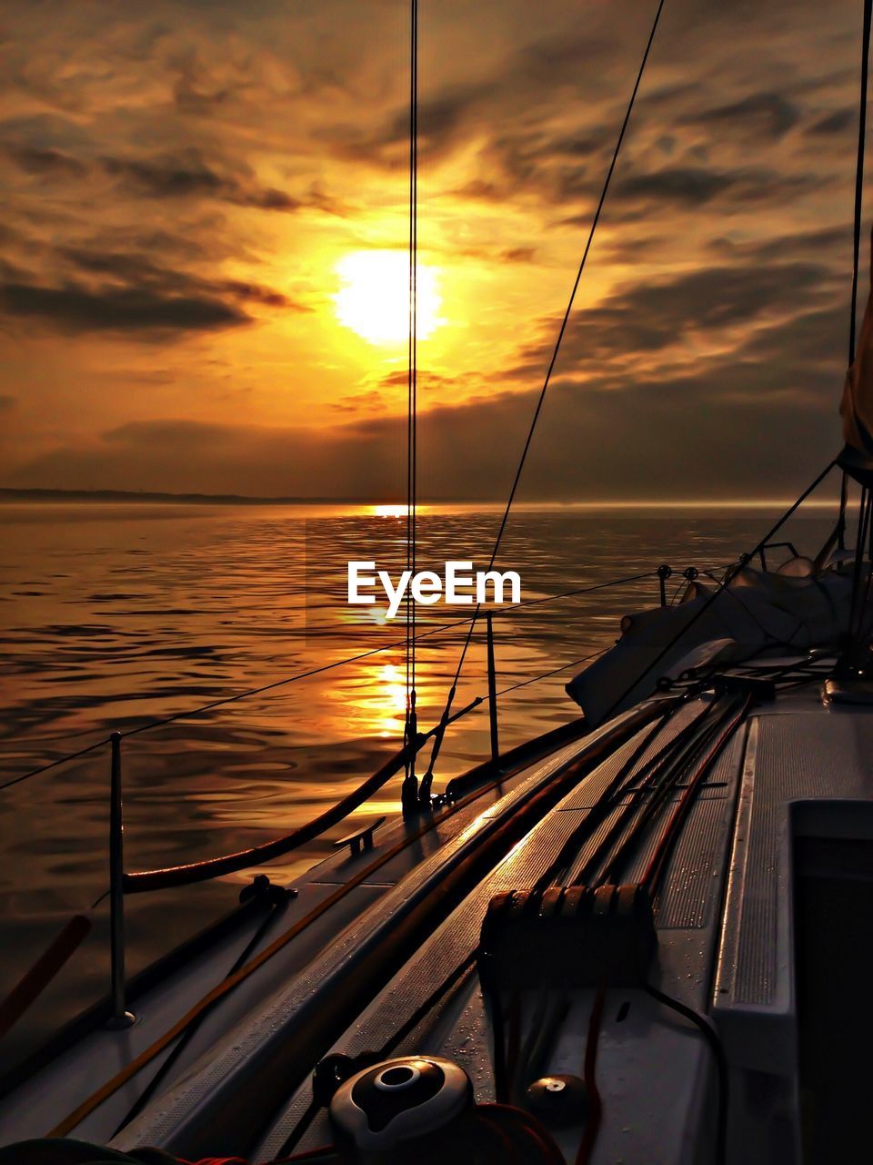 Sailboat on sea at sunset