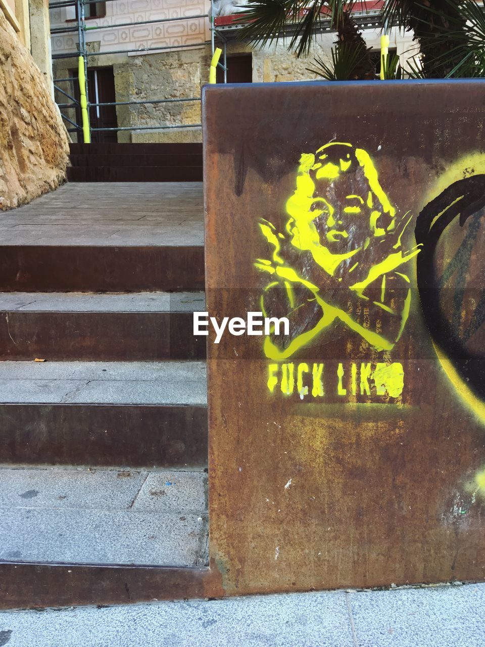 TEXT ON STONE WALL WITH STAIRCASE