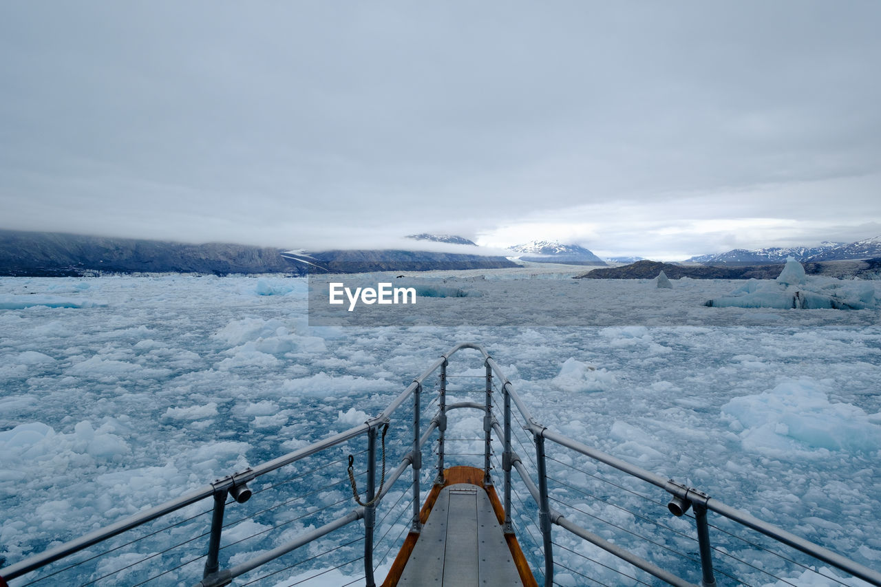 High angle view of cropped ship in frozen river during winter