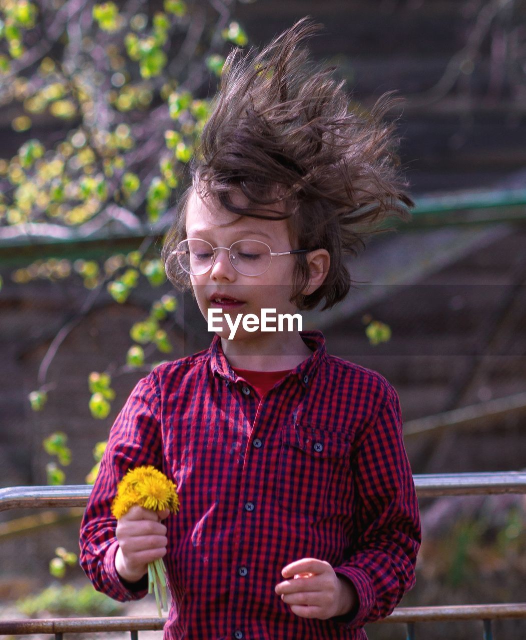 Boy holding flowers outdoors