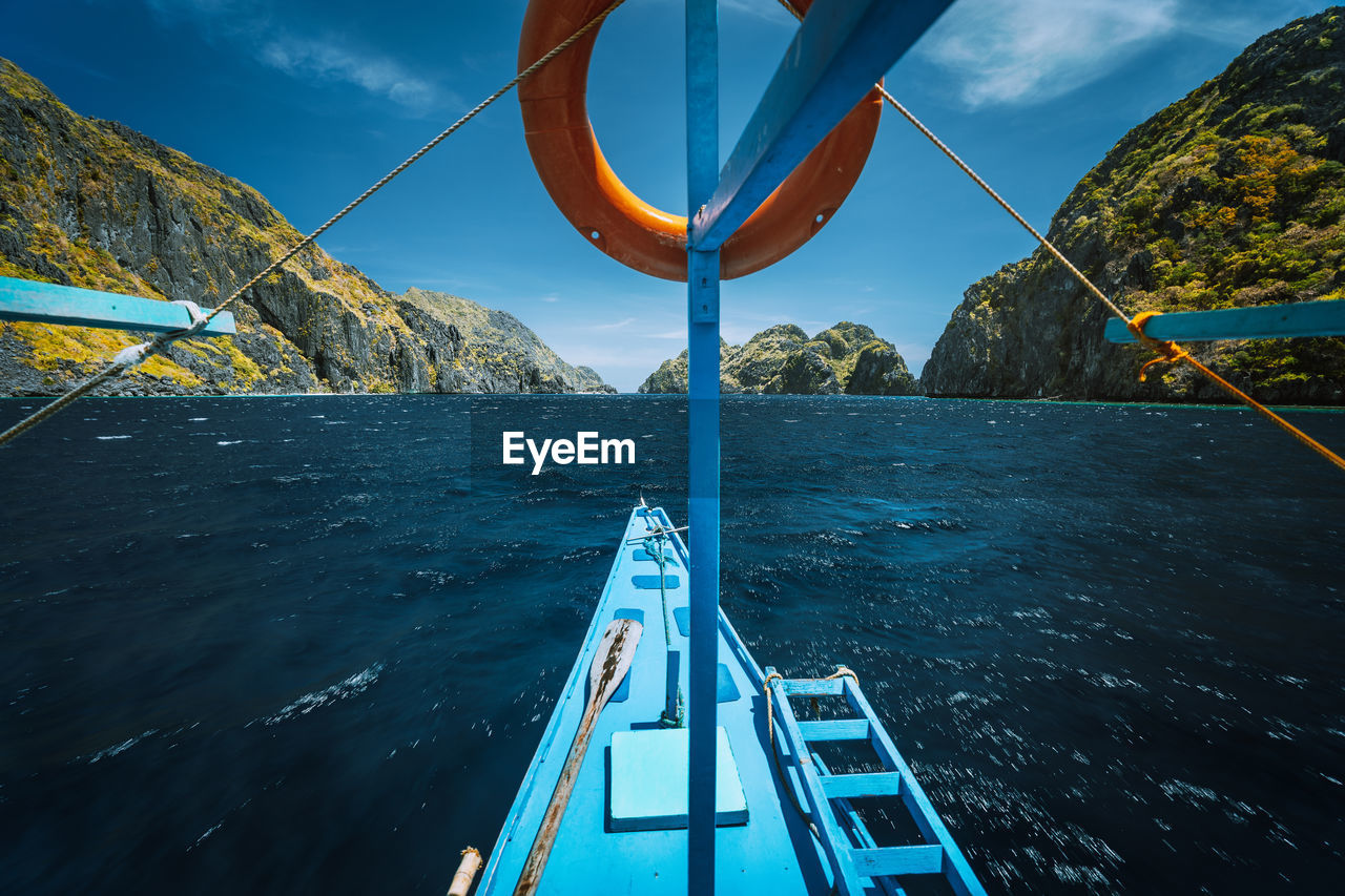 SAILBOAT ON SEA AGAINST BLUE SKY