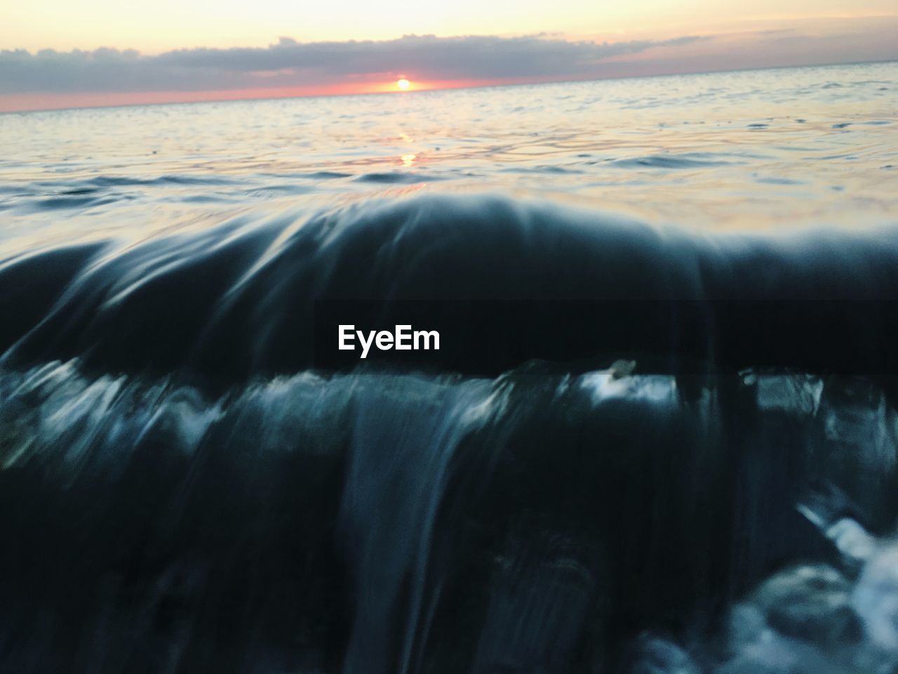 CLOSE-UP OF SEA DURING SUNSET