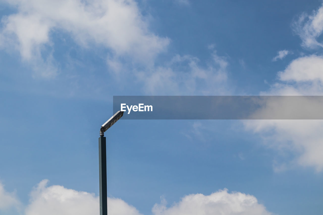 Low angle view of lighting equipment against sky