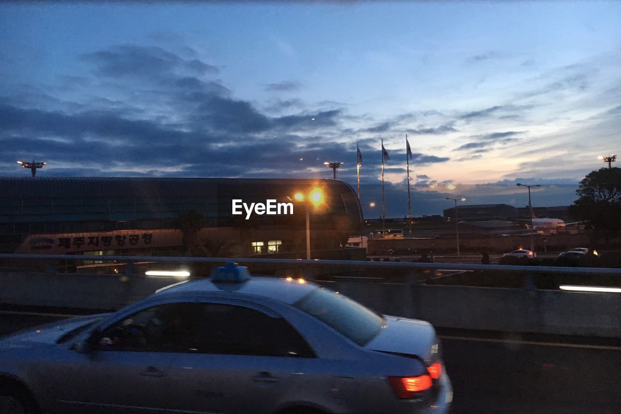 CARS ON ROAD AT SUNSET