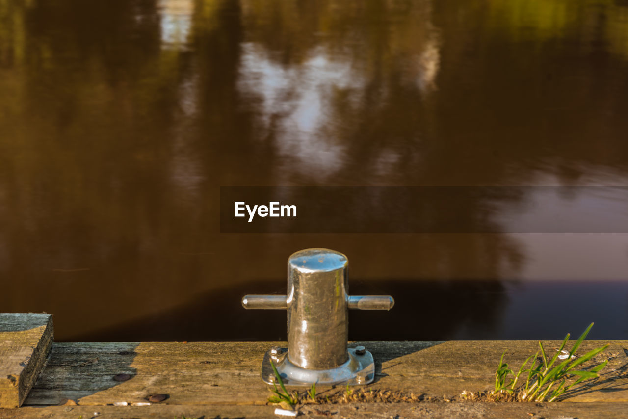 CLOSE-UP OF FAUCET IN CONTAINER