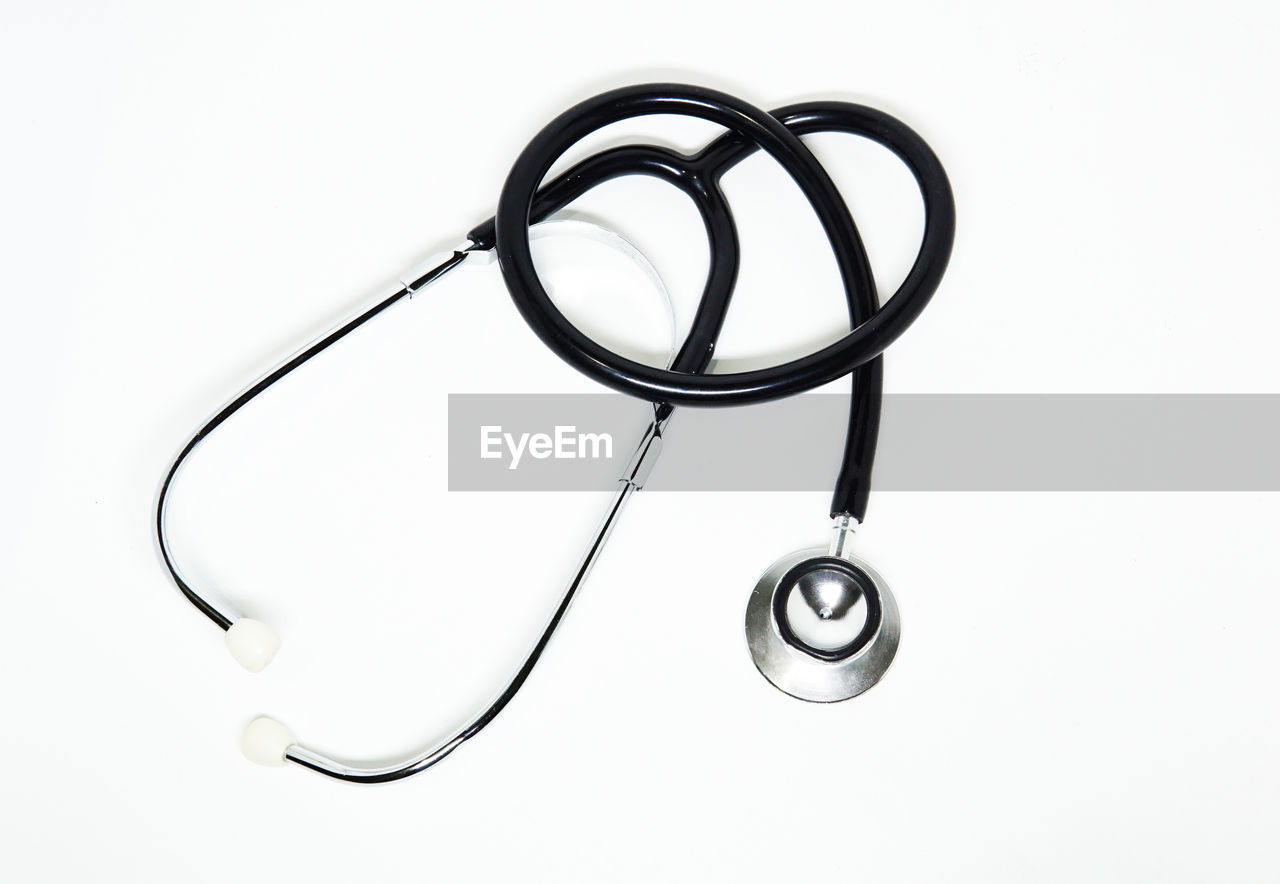 High angle view of stethoscope against white background