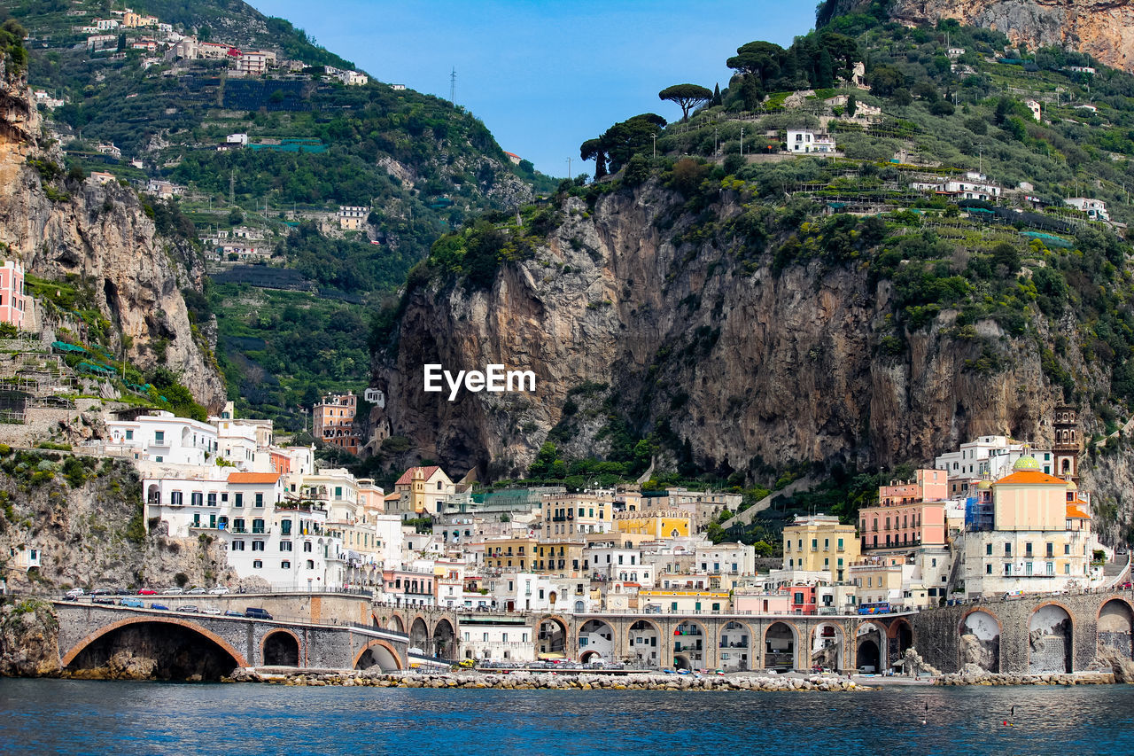 VIEW OF BUILDINGS IN CITY AGAINST MOUNTAIN