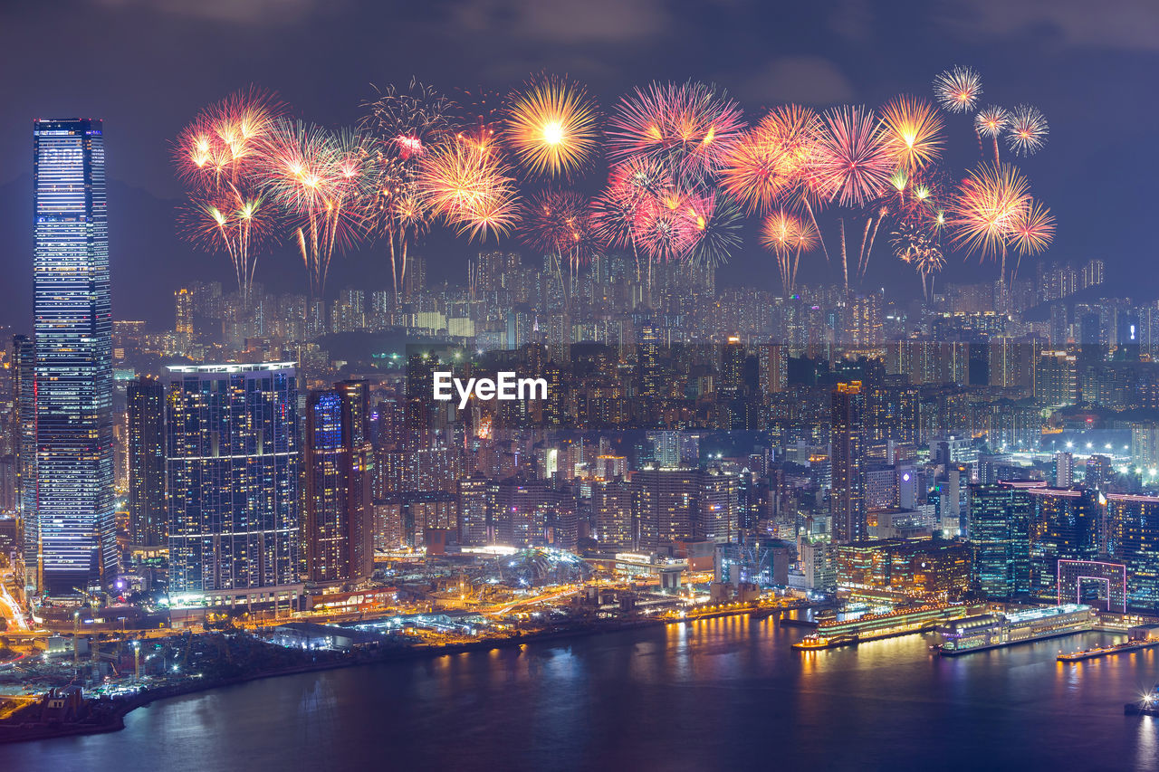 FIREWORK DISPLAY OVER RIVER AGAINST SKY