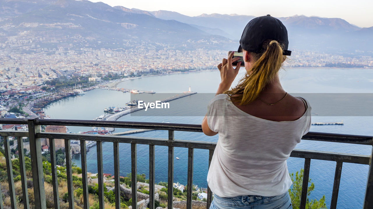 WOMAN LOOKING AT CITYSCAPE