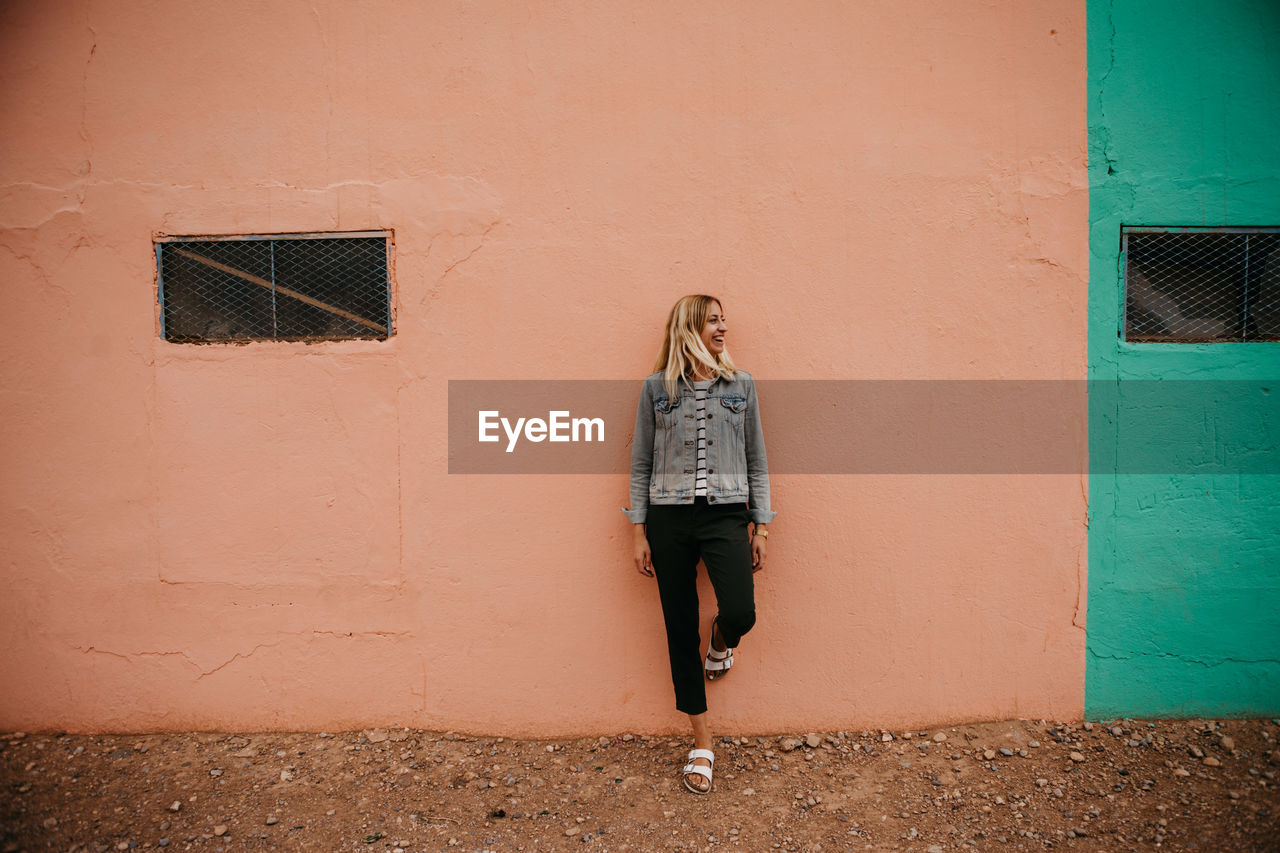 Woman standing against wall