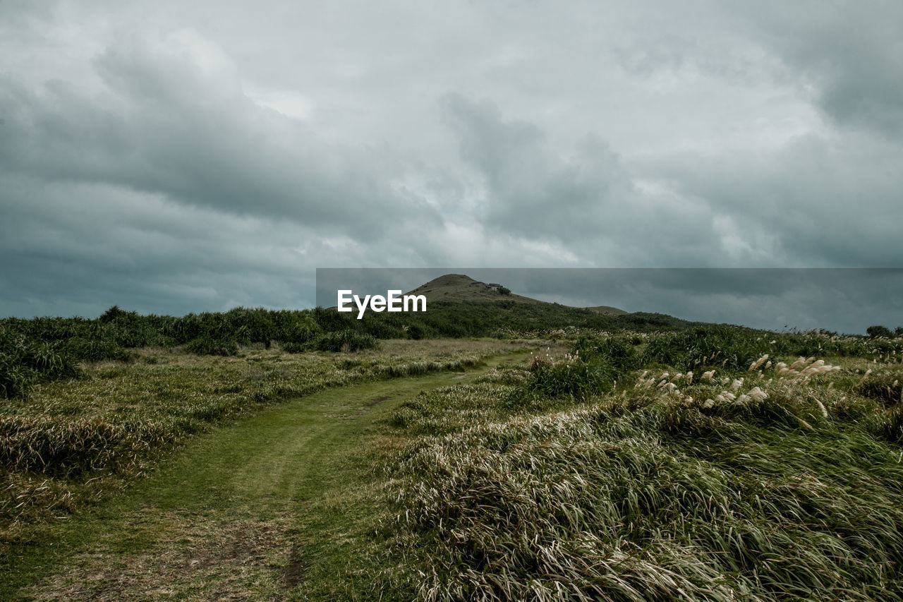 SCENIC VIEW OF LAND AND MOUNTAINS AGAINST SKY