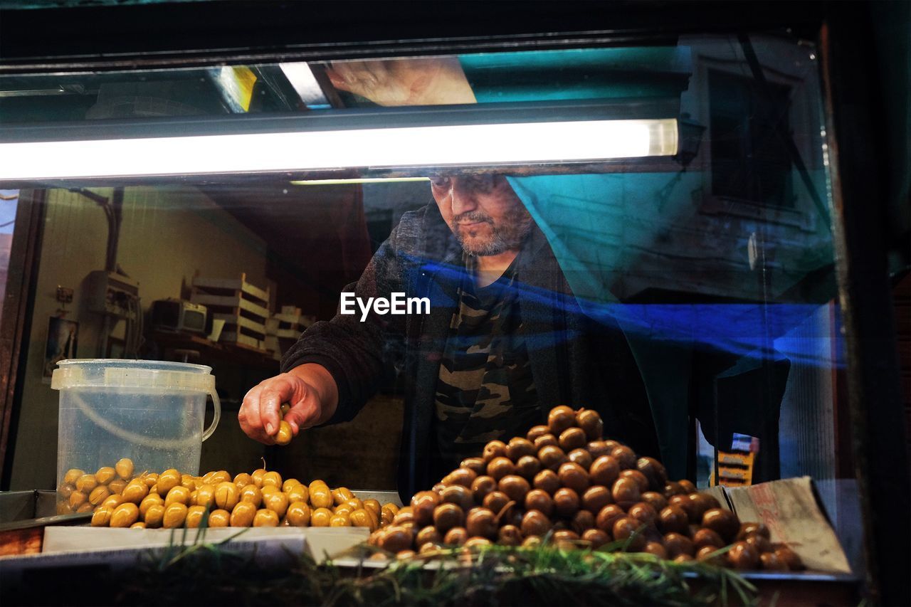 MAN WORKING IN CONTAINER AT MARKET