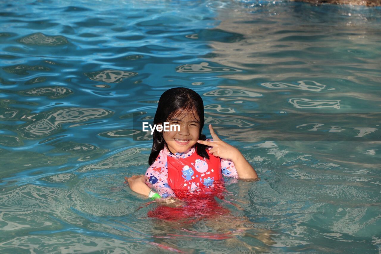 Portrait of girl swimming in pool