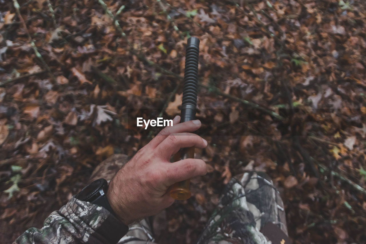 Cropped image of man holding pipe