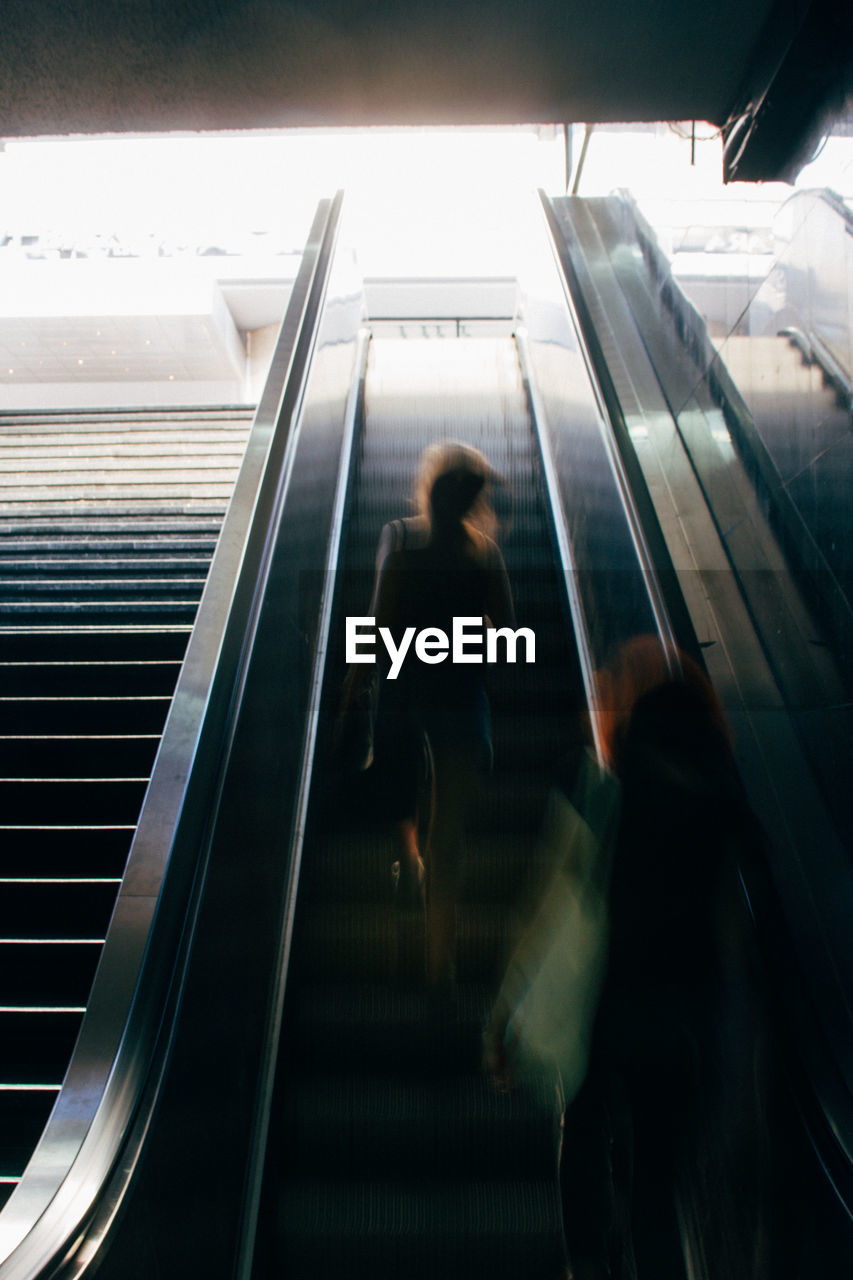 Blurred motion of people on escalator