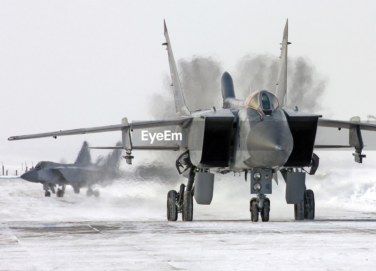 AIRPLANE ON SNOW COVERED LANDSCAPE