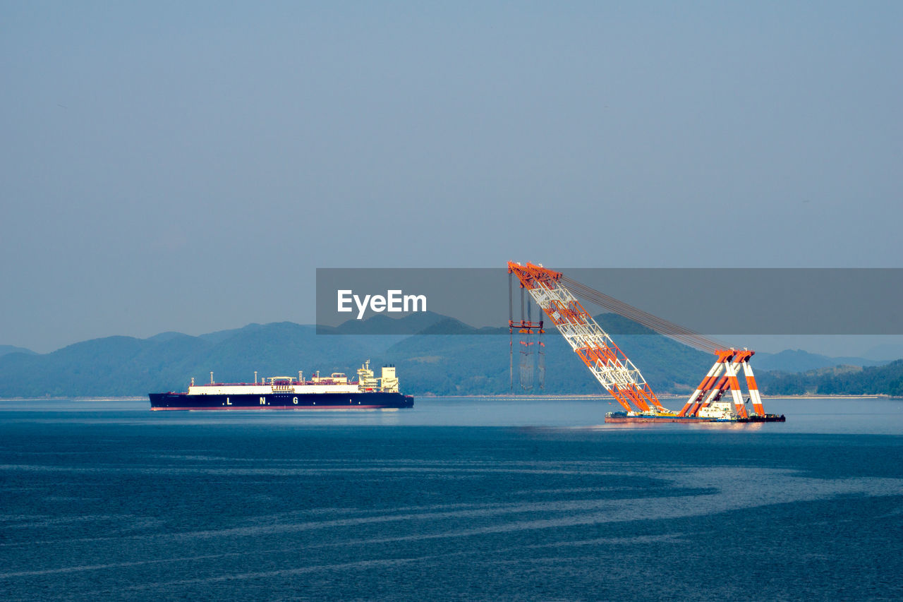 SHIP IN SEA AGAINST CLEAR BLUE SKY