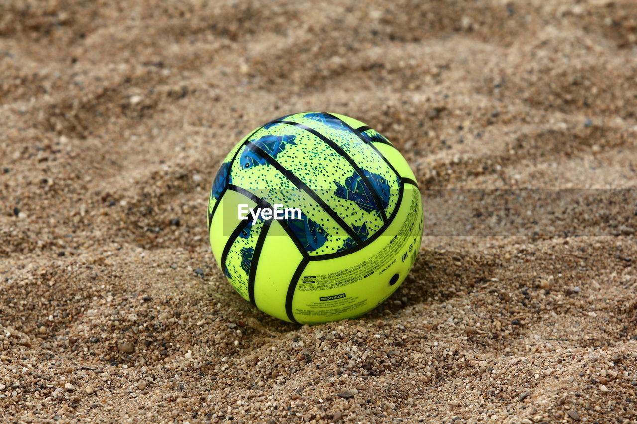 Green ball on sand