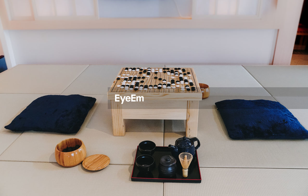 HIGH ANGLE VIEW OF SHOES ON TABLE AT HOME