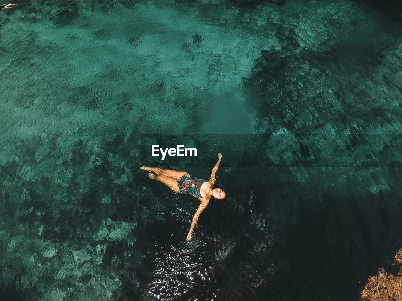 High angle view of woman swimming in sea