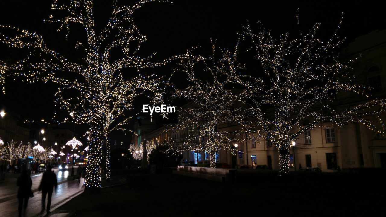 VIEW OF ILLUMINATED CITY AT NIGHT