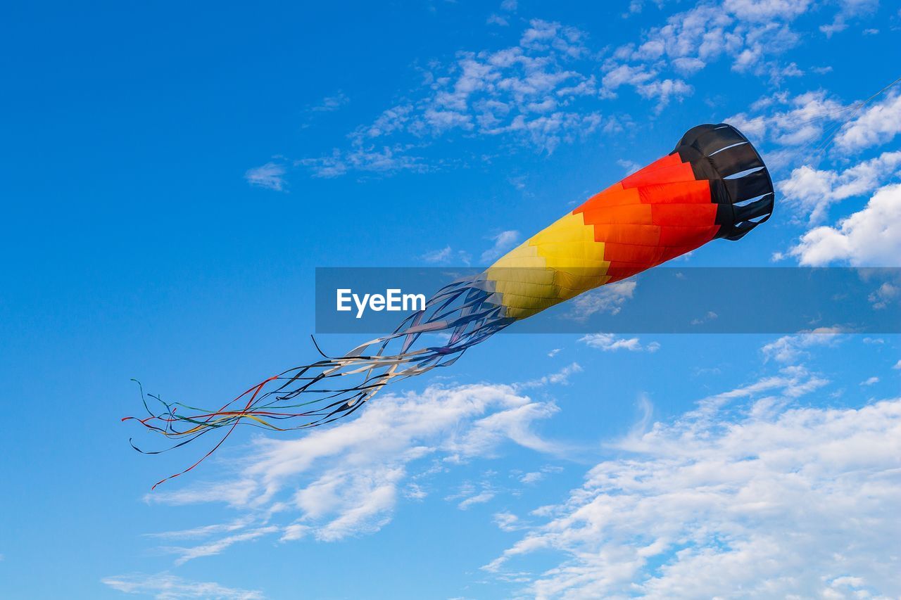 LOW ANGLE VIEW OF MULTI COLORED FLAG AGAINST SKY