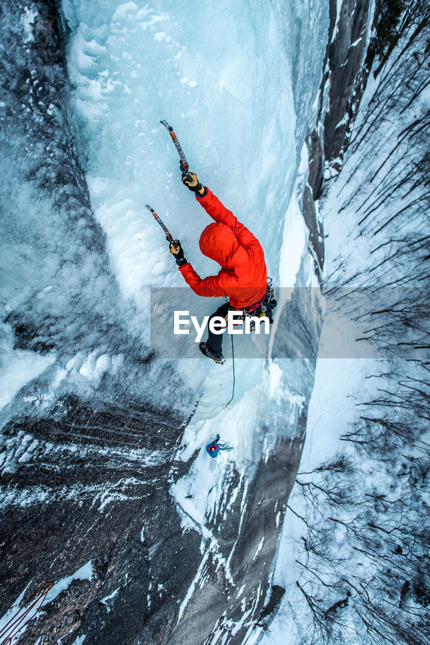 Man ice climbing on cathedral ledge in north conway, new hampshire