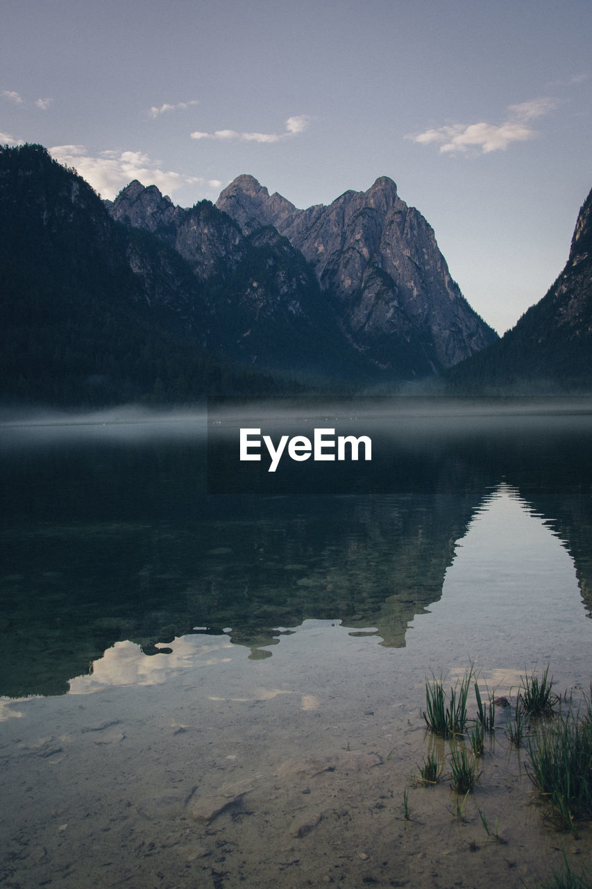 Scenic view of lake and mountains against sky