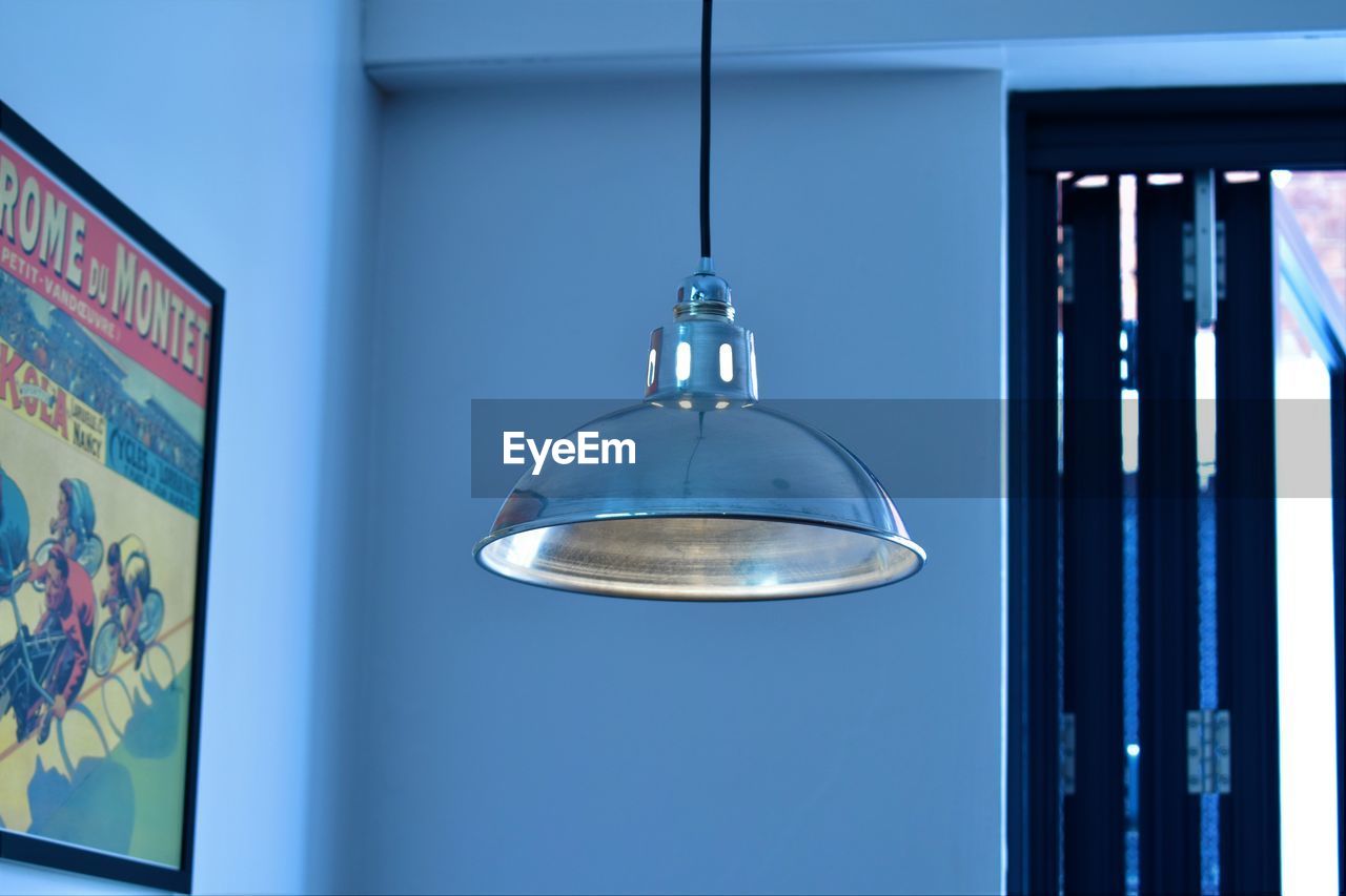 Pendant light hanging against wall