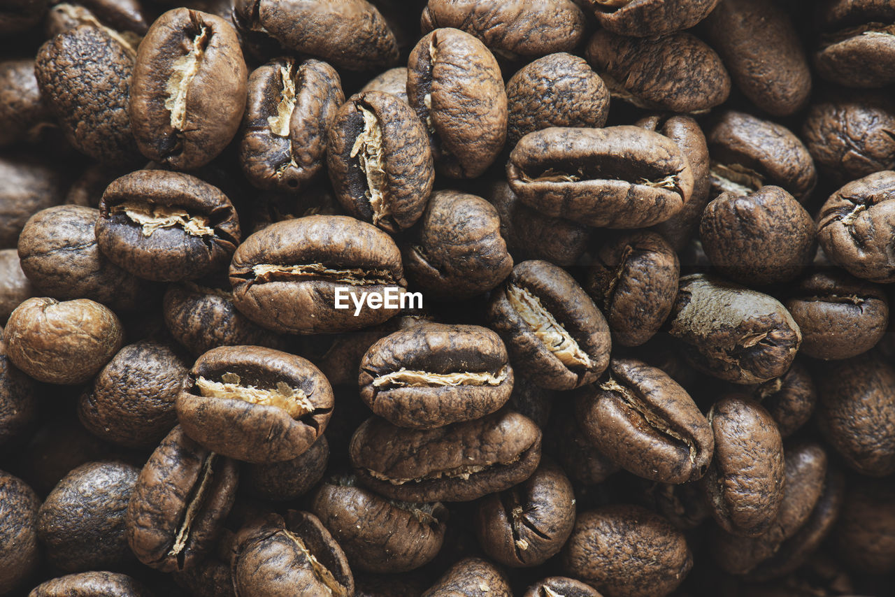 FULL FRAME SHOT OF COFFEE BEANS IN BACKGROUND