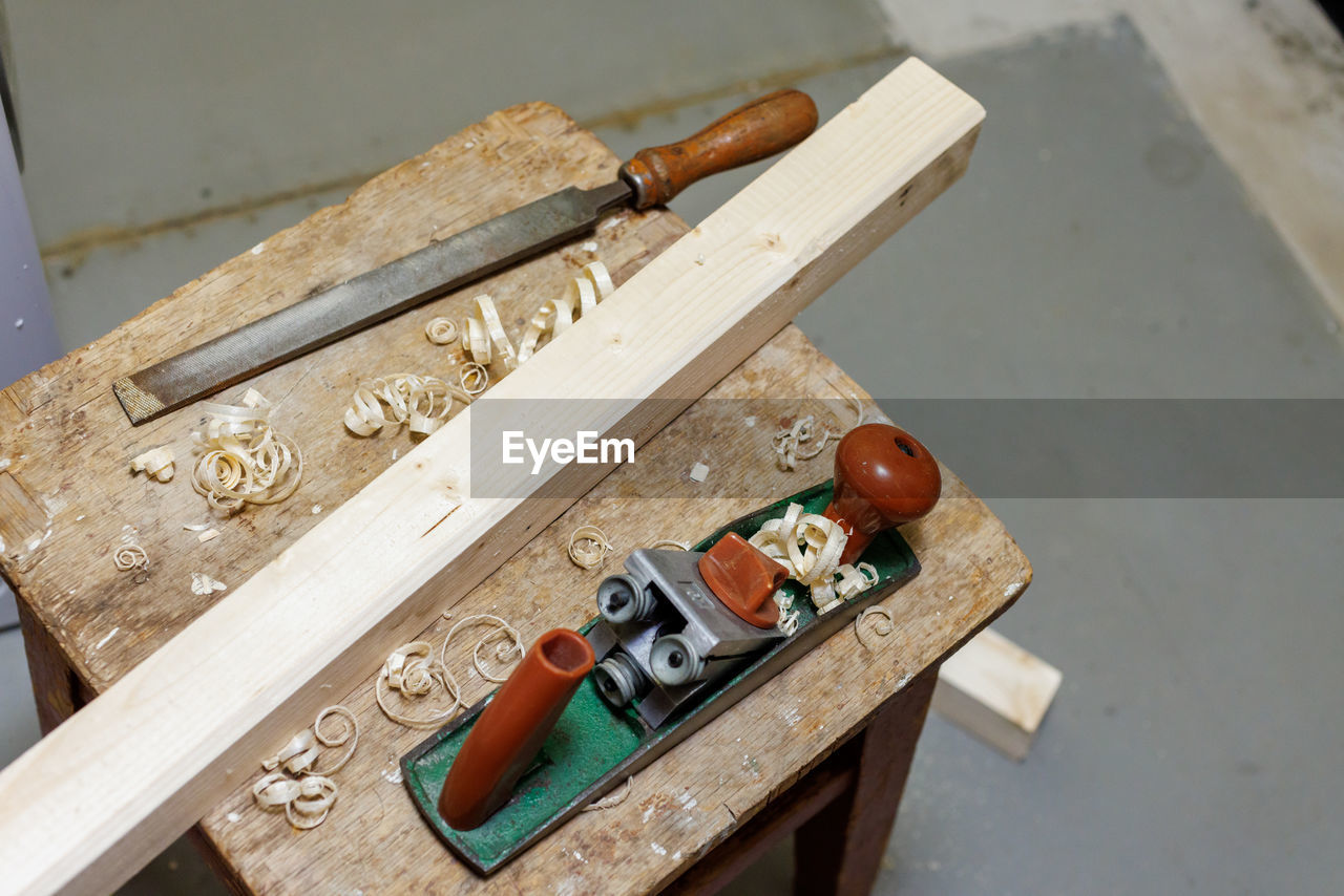 Planer, file and wooden block on a stool