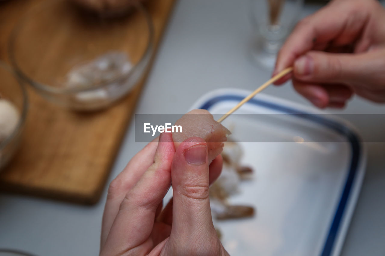 Close-up of cropped hands preparing food