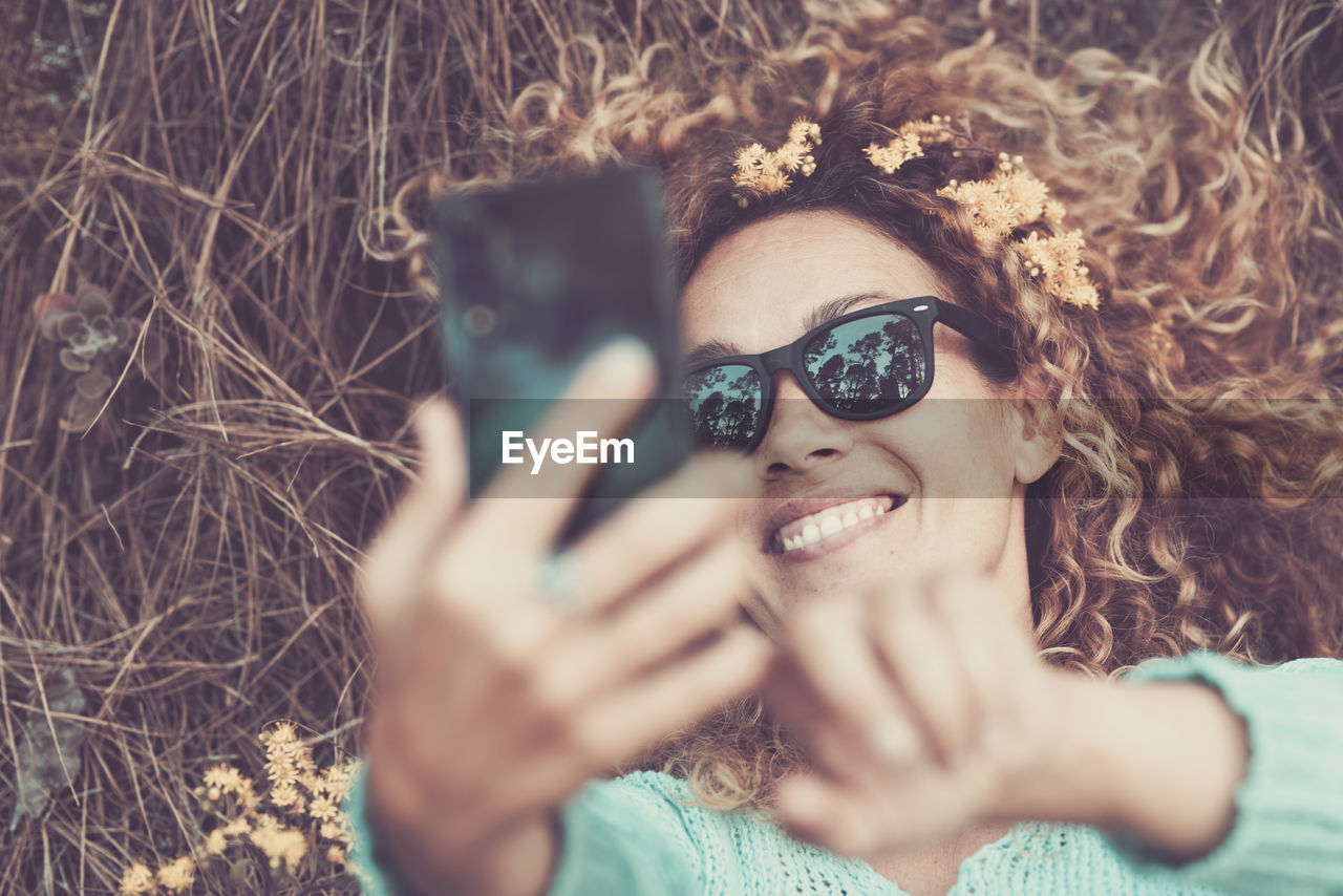 High angle view of woman taking selfie outdoors