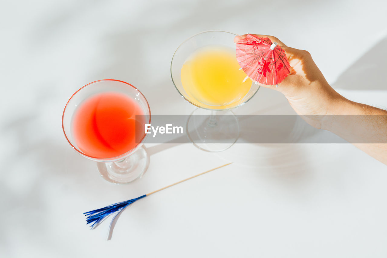 Alcoholic cocktails with marked shadows of the midday sun