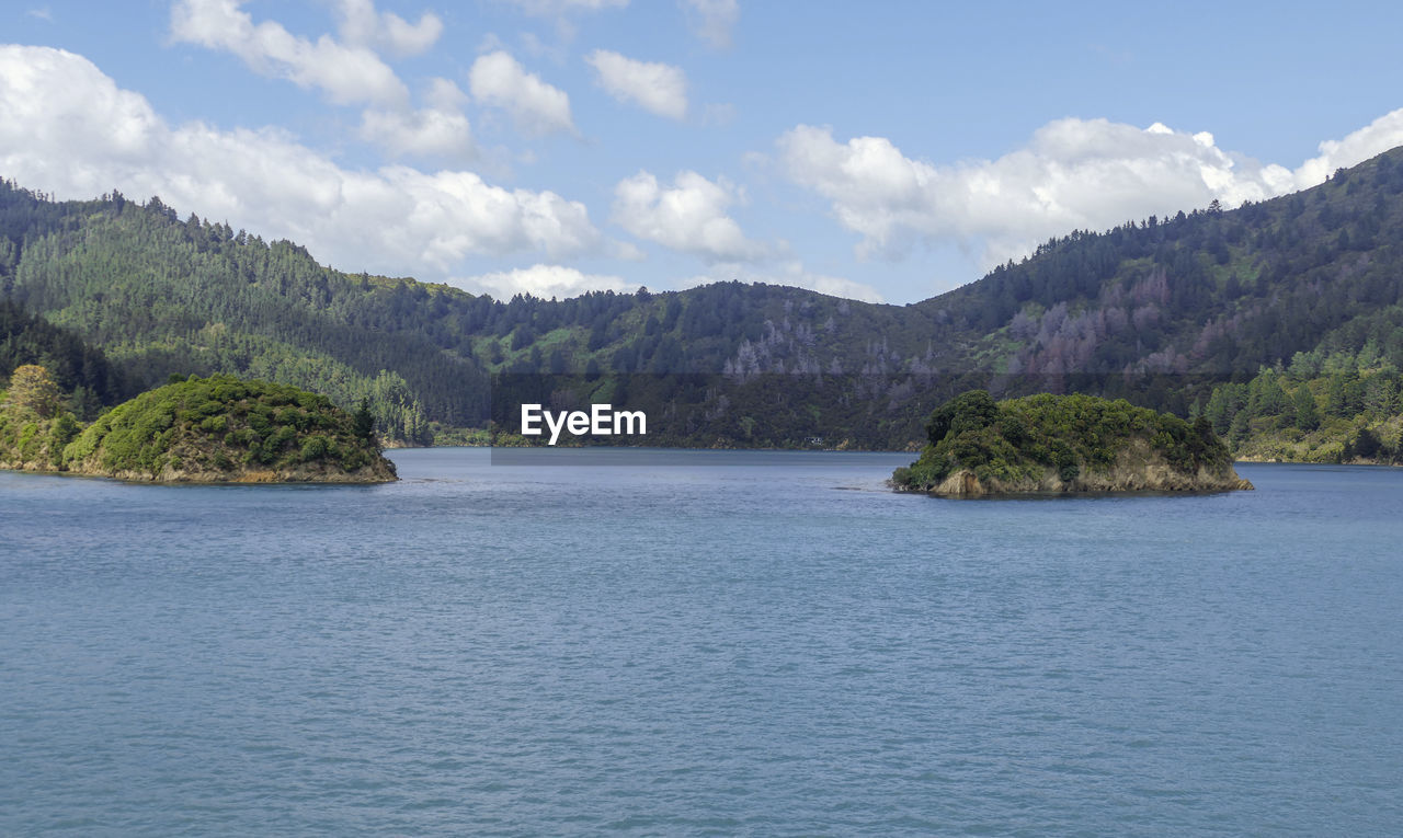 SCENIC VIEW OF MOUNTAINS AND SEA AGAINST SKY