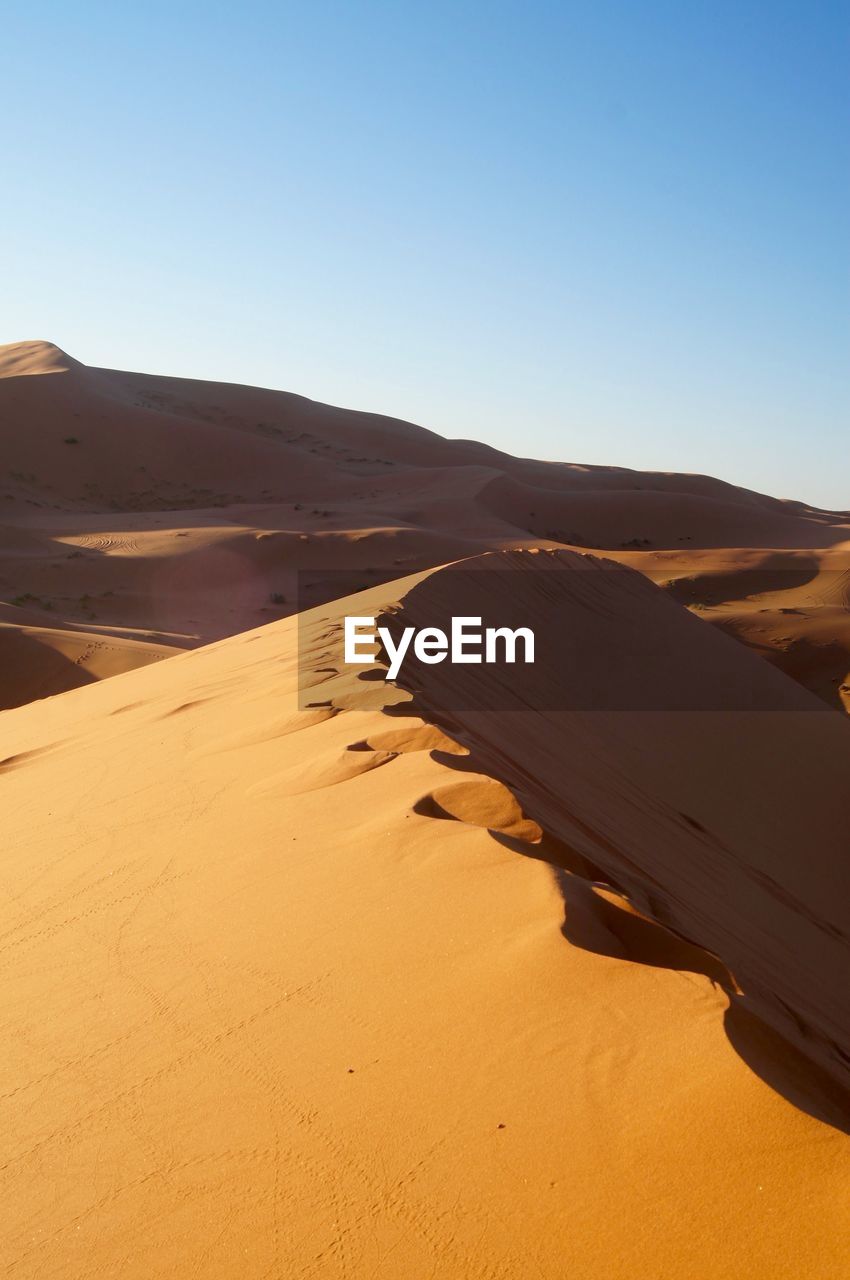 Scenic view of desert against clear sky