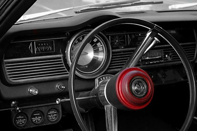 CLOSE-UP OF VINTAGE CAR ON ROAD