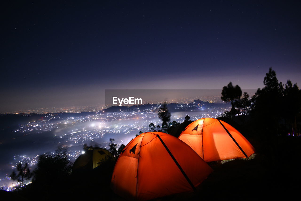 Tent on field against sky at night