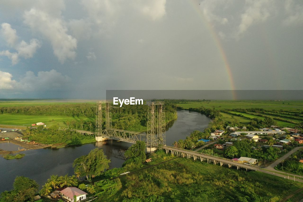 High angle view of henar bridge with a rainbow in background in district nickerie, suriname.