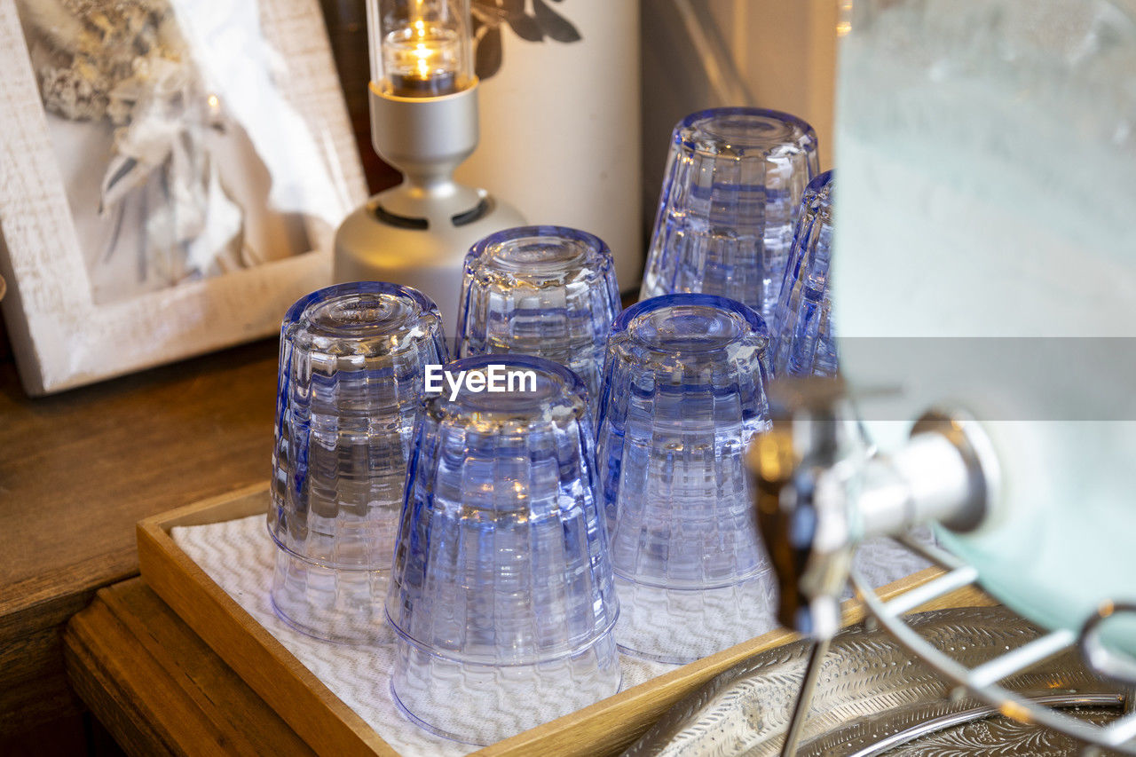 indoors, household equipment, table, no people, glass, food and drink, lighting, drinking glass, container, drink