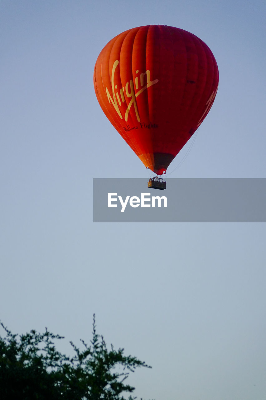 LOW ANGLE VIEW OF HOT AIR BALLOONS AGAINST CLEAR SKY