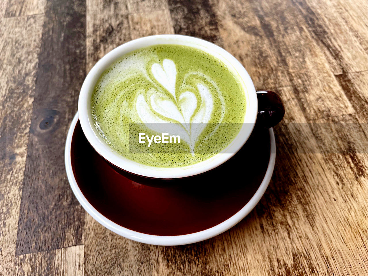 drink, food and drink, cup, mug, refreshment, hot drink, coffee cup, coffee, frothy drink, crockery, saucer, wood, latte, food, cappuccino, still life, matcha tea, tea, table, no people, freshness, produce, green, indoors, close-up, froth art, high angle view, wellbeing, healthy eating, creativity