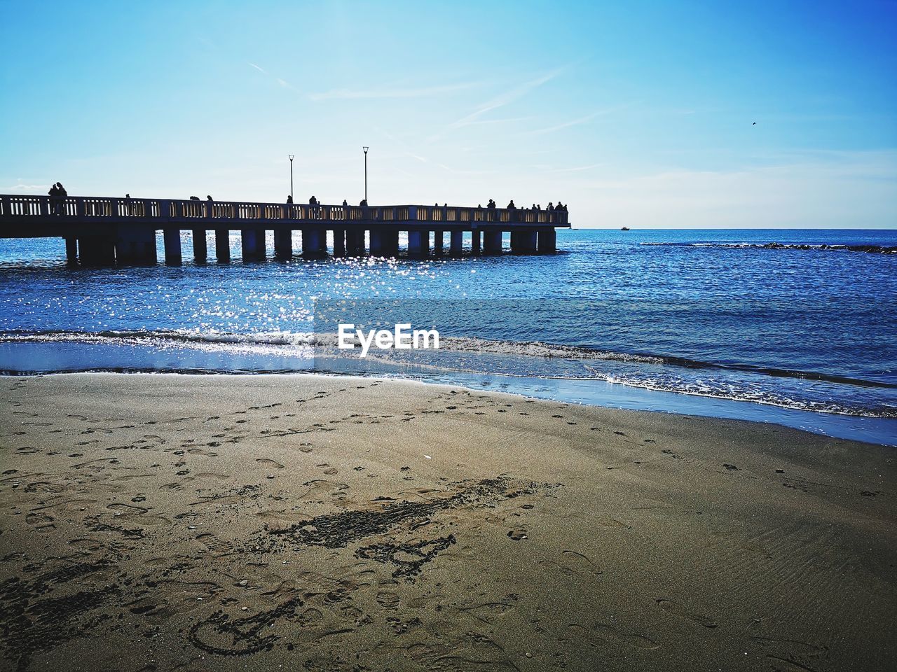 PIER ON BEACH AGAINST SKY