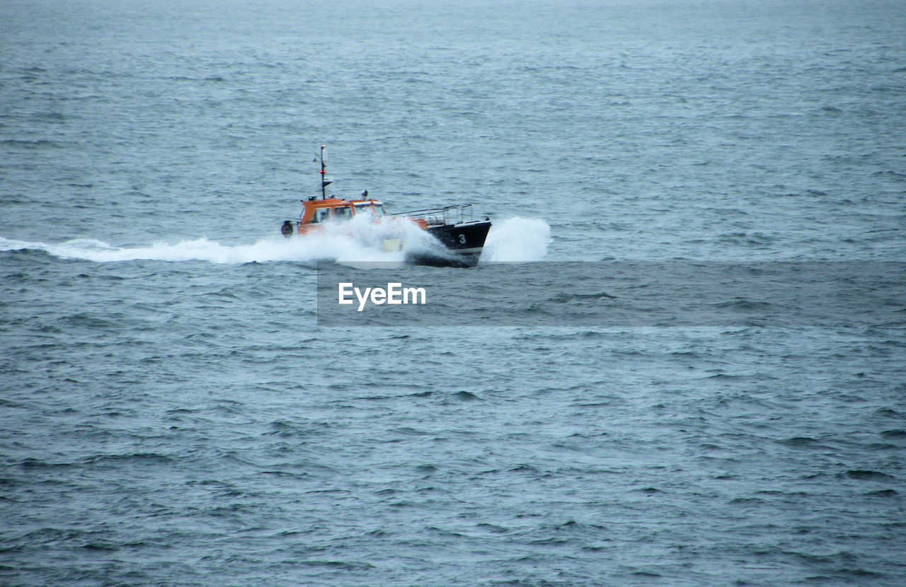 PEOPLE SAILING ON SEA