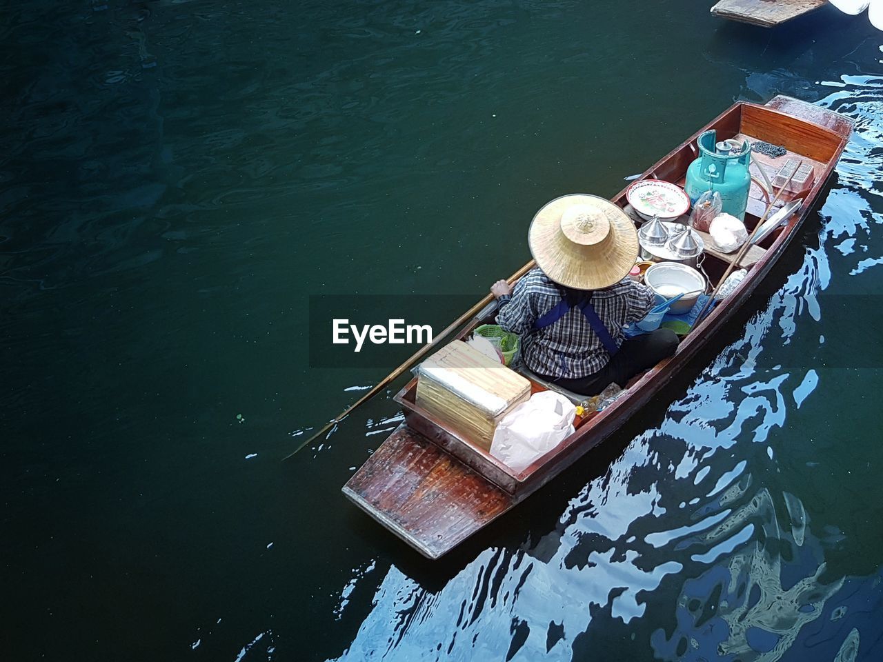 High angle view of vendor sailing in canal